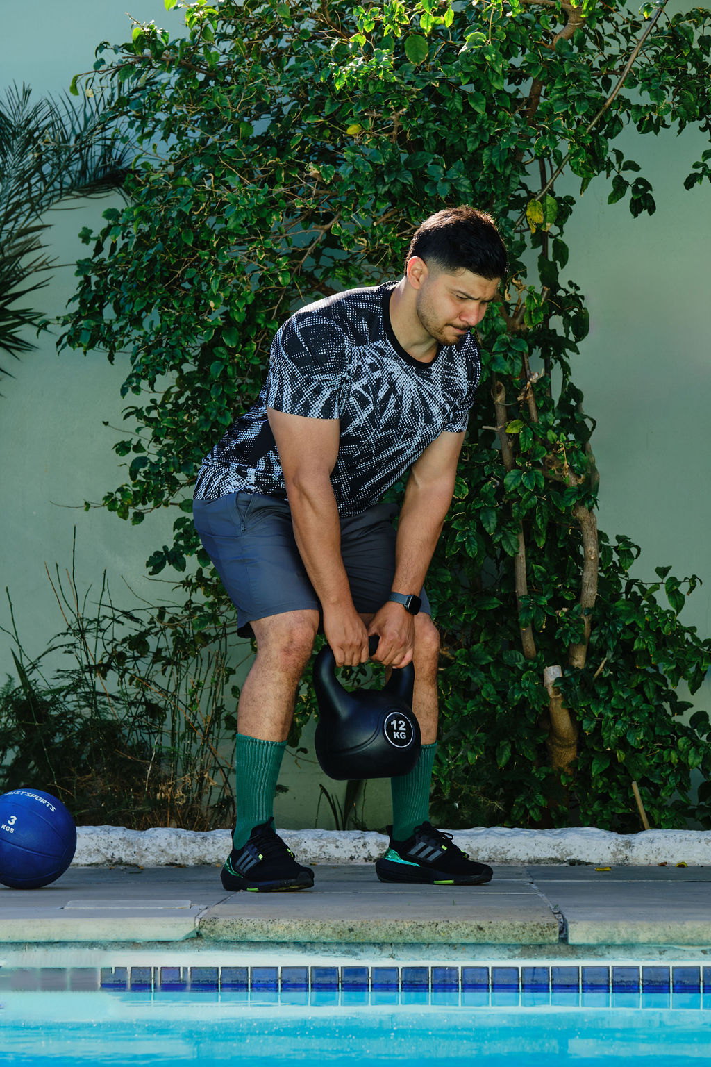 personal trainer deadlifting a kettlebell