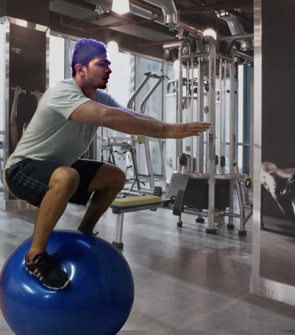 personal trainer balancing on a ball