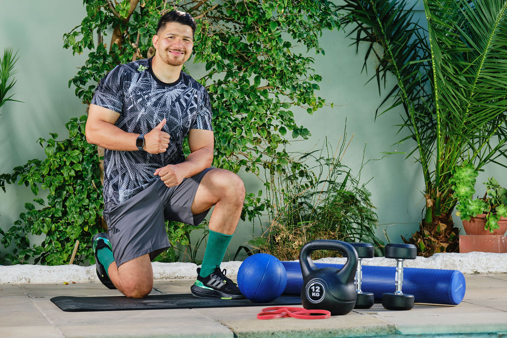 personal trainer kneeling on one leg